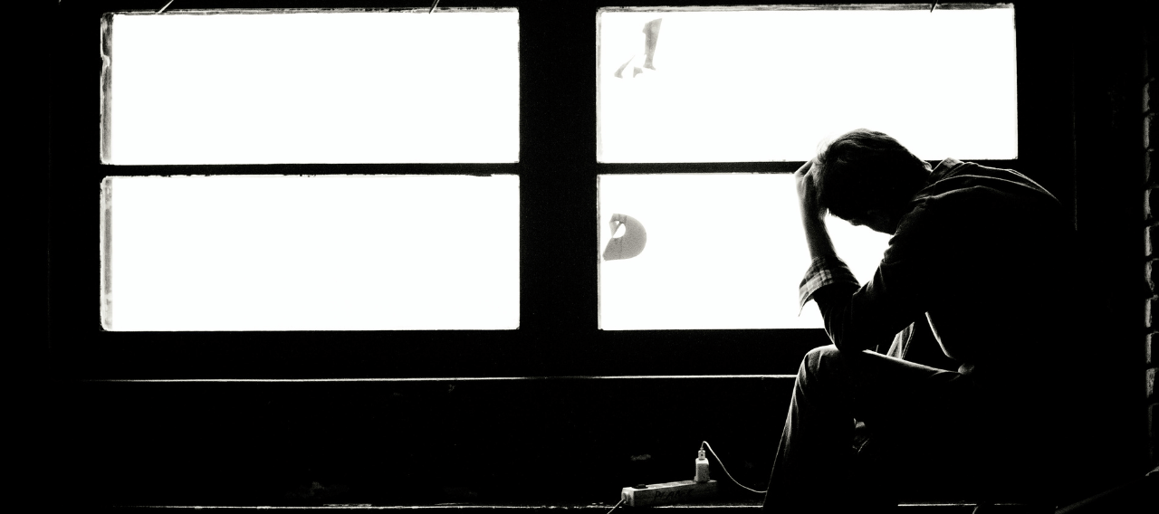 Sorrow express by someone sitting by the window